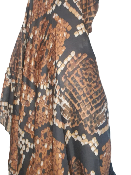 Model wearing a beige and brown abstract cotton modal print hijab draped over the shoulders, side profile view.