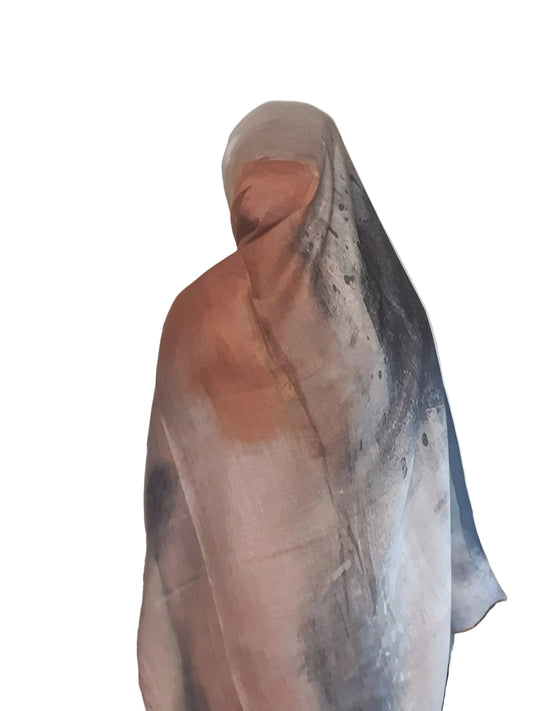 Model wearing a beige brown abstract cotton modal hijab draped softly from the side