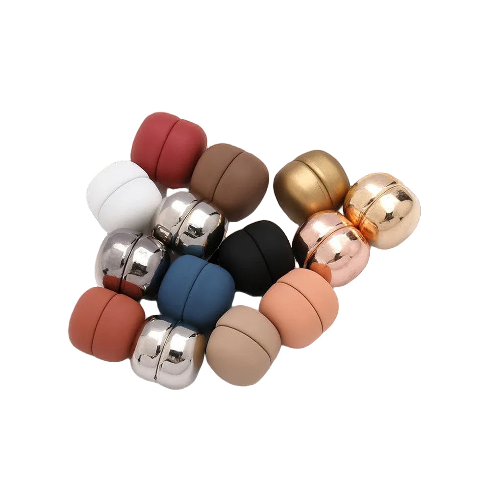 Set of small, round, metallic objects on a satin fabric background