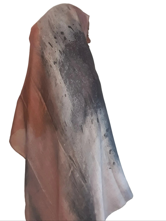 Model wearing a beige brown cotton modal printed hijab showing full abstract pattern and fluid drape