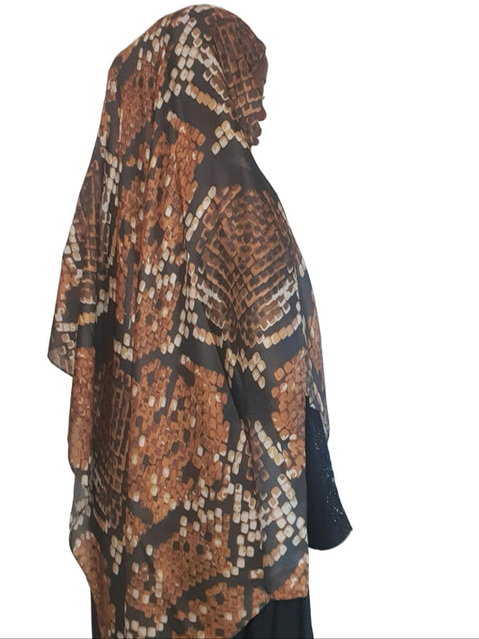 Model wearing a beige brown cotton modal printed hijab showing full back drape and abstract pattern.