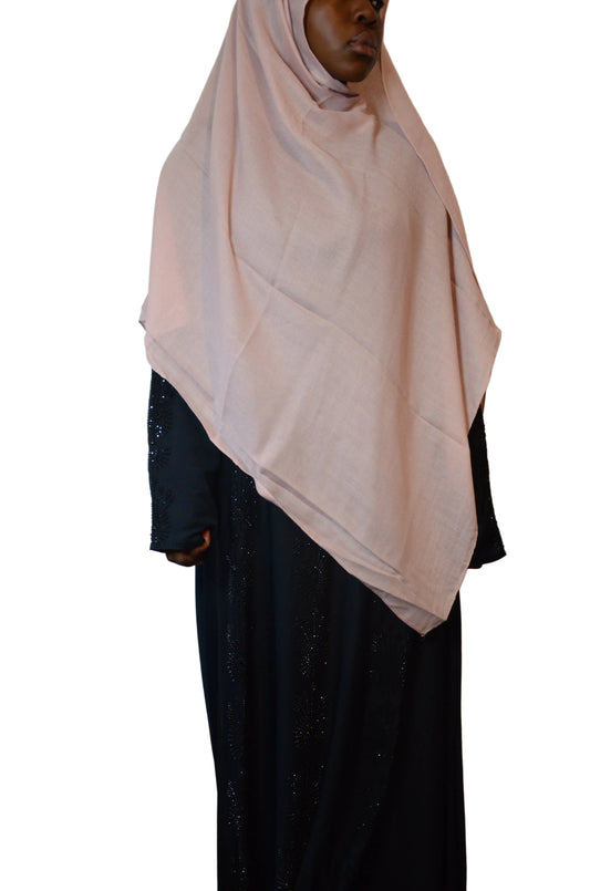 Model wearing a blush pink cotton linen hijab styled in a classic front drape with a soft, lightweight finish.