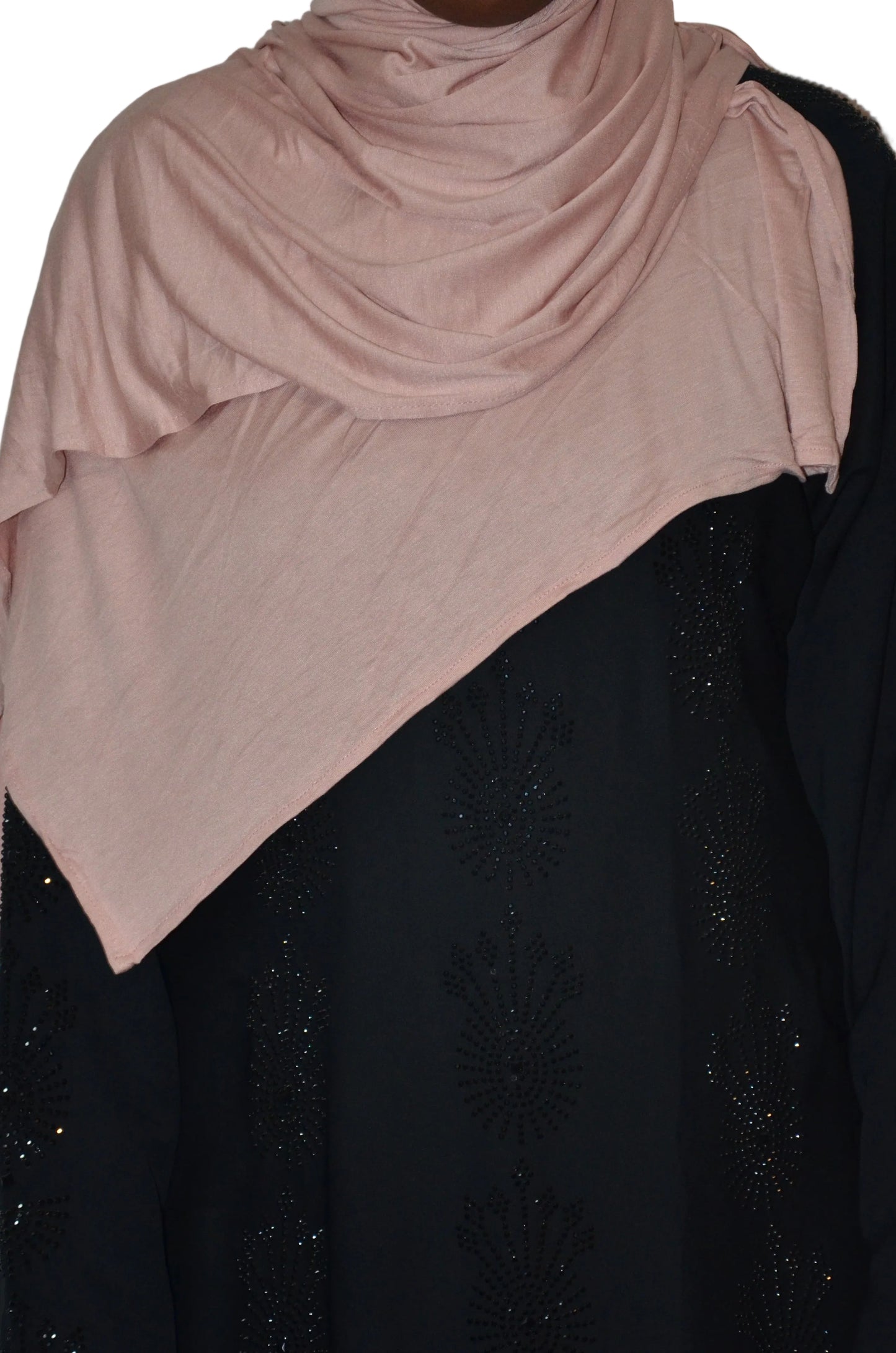 Model wearing a blush pink plain jersey hijab with soft drape and smooth finish