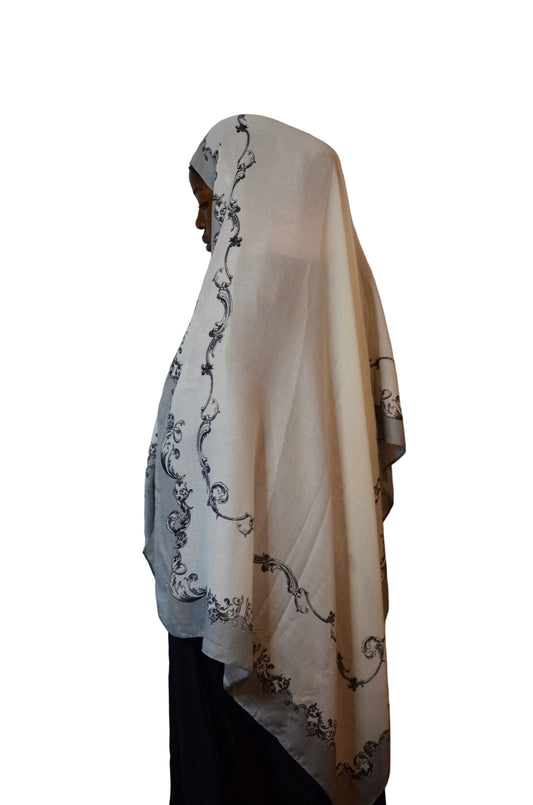 Model wearing an ivory and charcoal scroll print hijab showing lightweight cotton voile drape