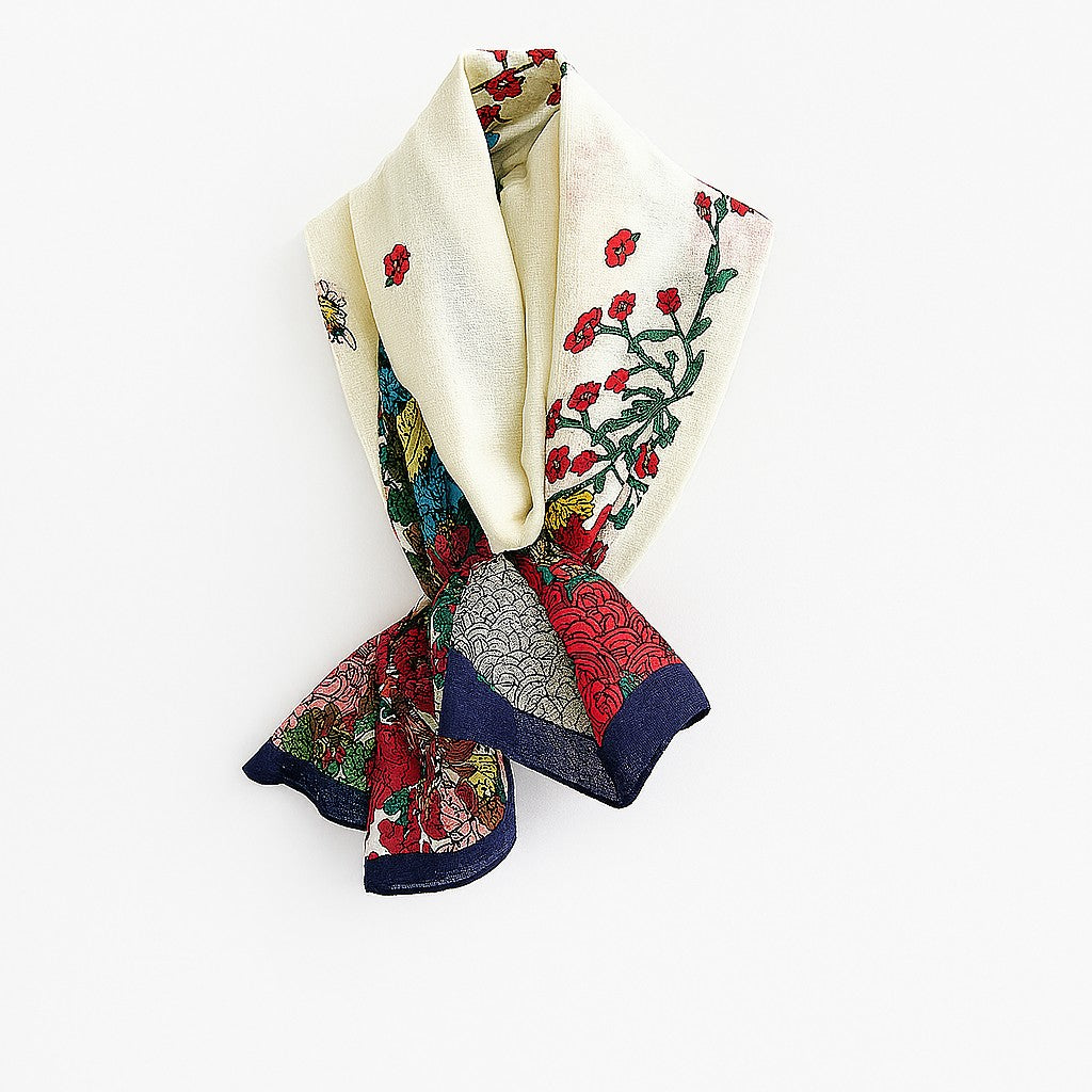 Cream cotton voile linen floral hijab with navy border shown folded to highlight floral detailing