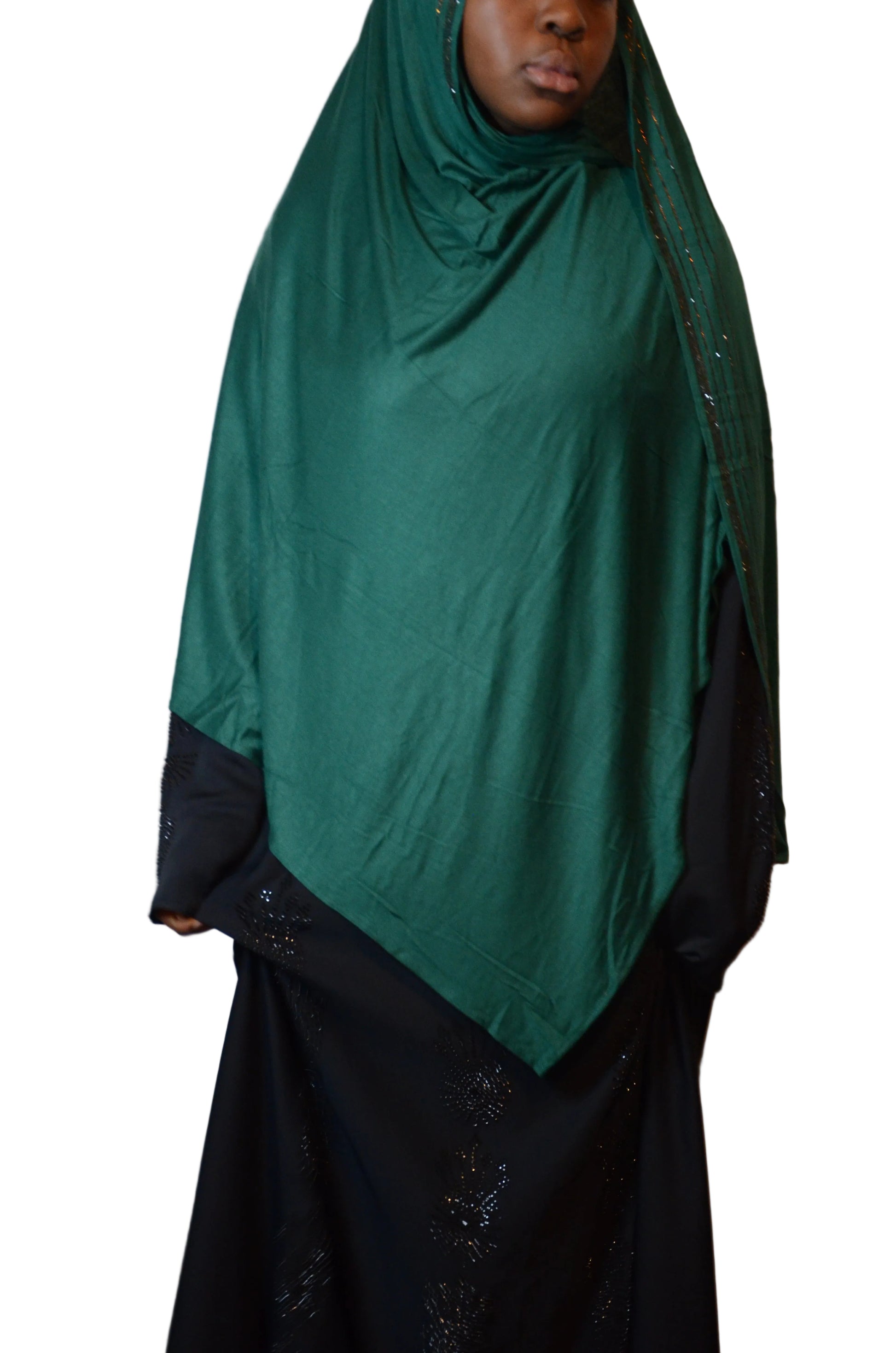 Model wearing emerald green premium jersey hijab with rhinestone embellishment, side profile view showing elegant drape