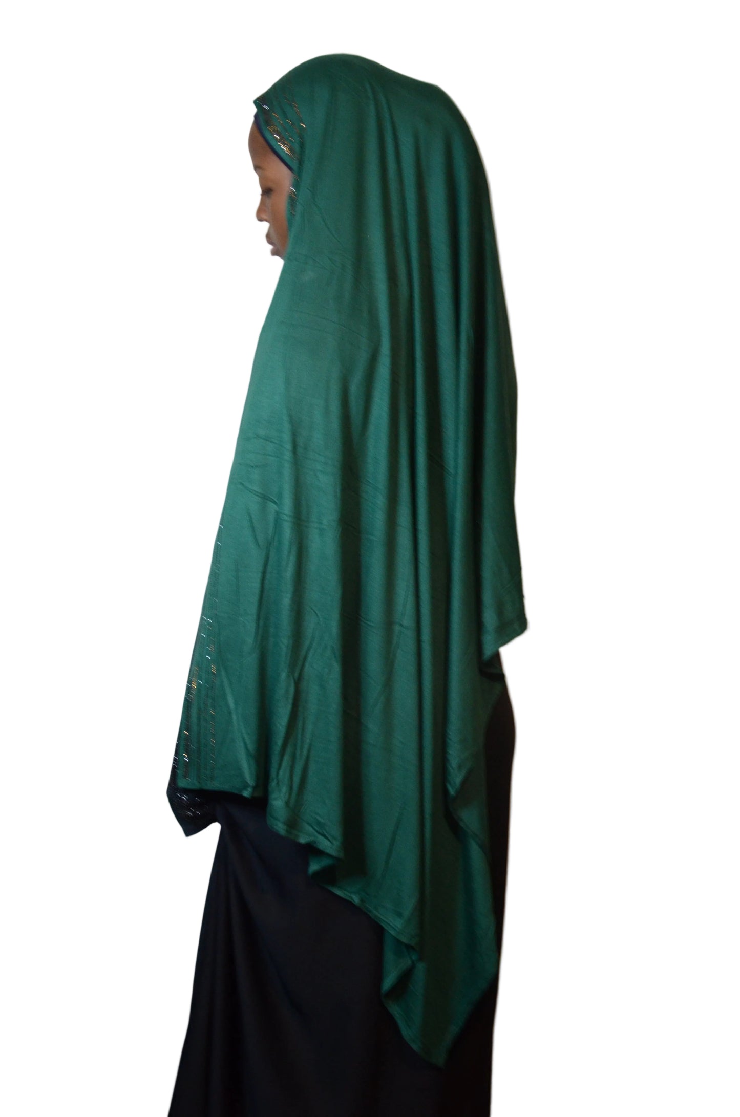 Model wearing emerald green rhinestone jersey hijab styled over a black abaya, front view highlighting soft fabric and subtle sparkle