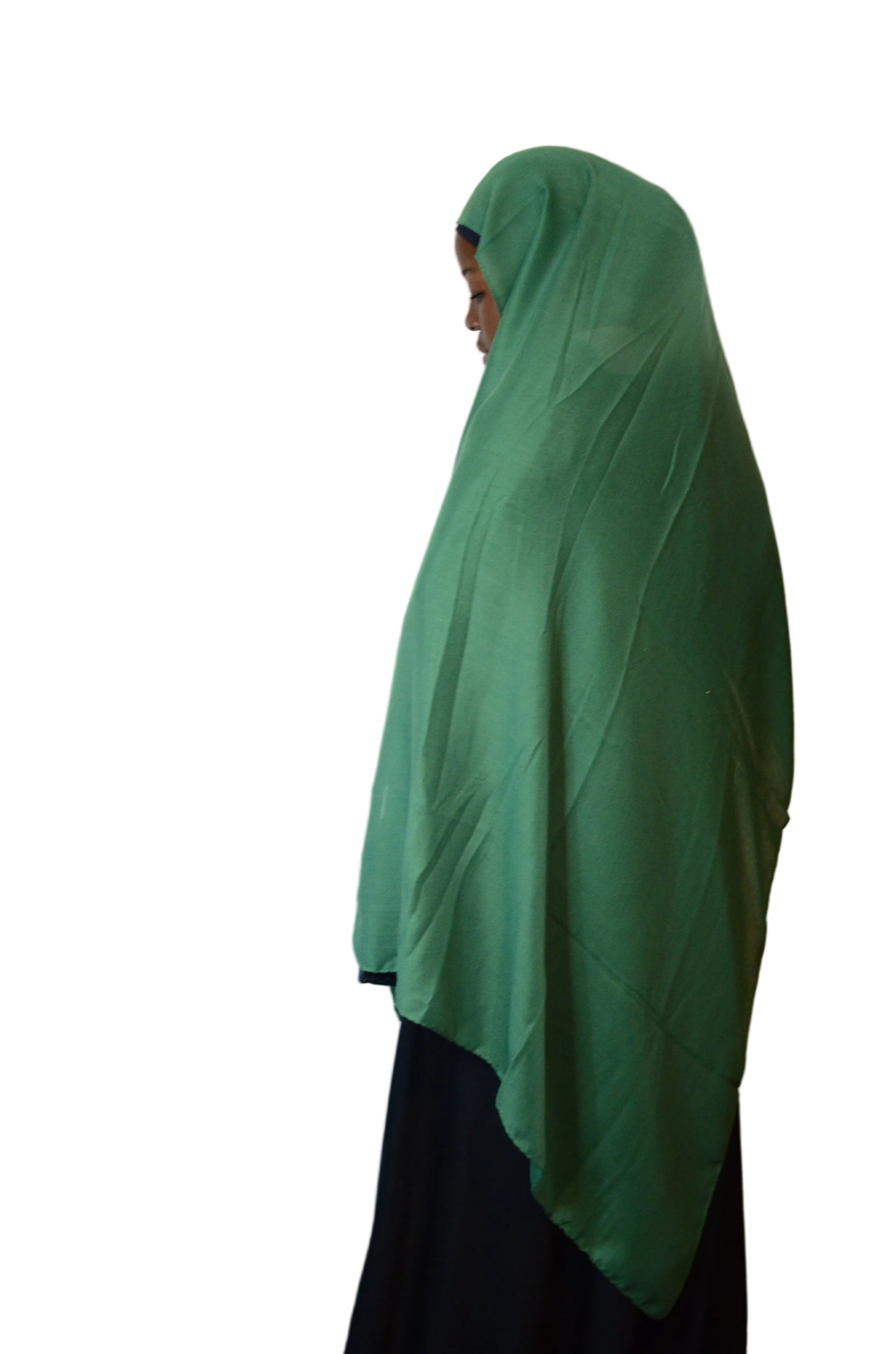 Model wearing a forest green cotton linen hijab from a side view, highlighting the breathable fabric and full coverage drape.