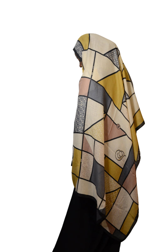 Model wearing the Modern Geometric Modal Hijab in neutral beige, mustard, and grey tones, shown in