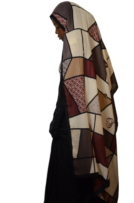Patchwork-patterned coat on a mannequin against a plain background