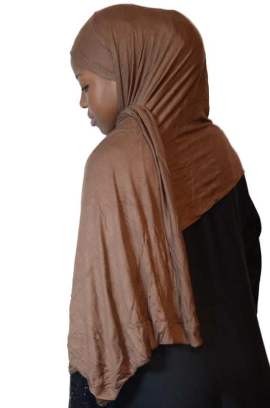 Model wearing a mocha brown tie-back cotton jersey hijab with a soft drape and matte finish.