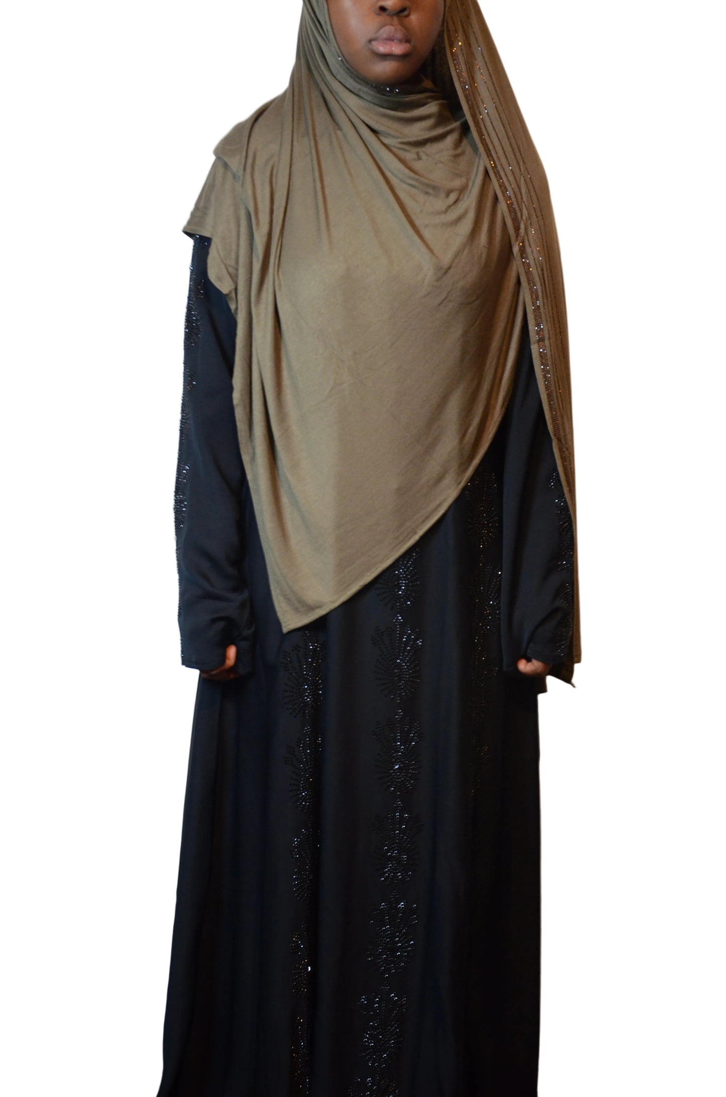Model wearing an olive stone premium jersey hijab with subtle rhinestone trim, styled for full coverage with a smooth drape over a black abaya.