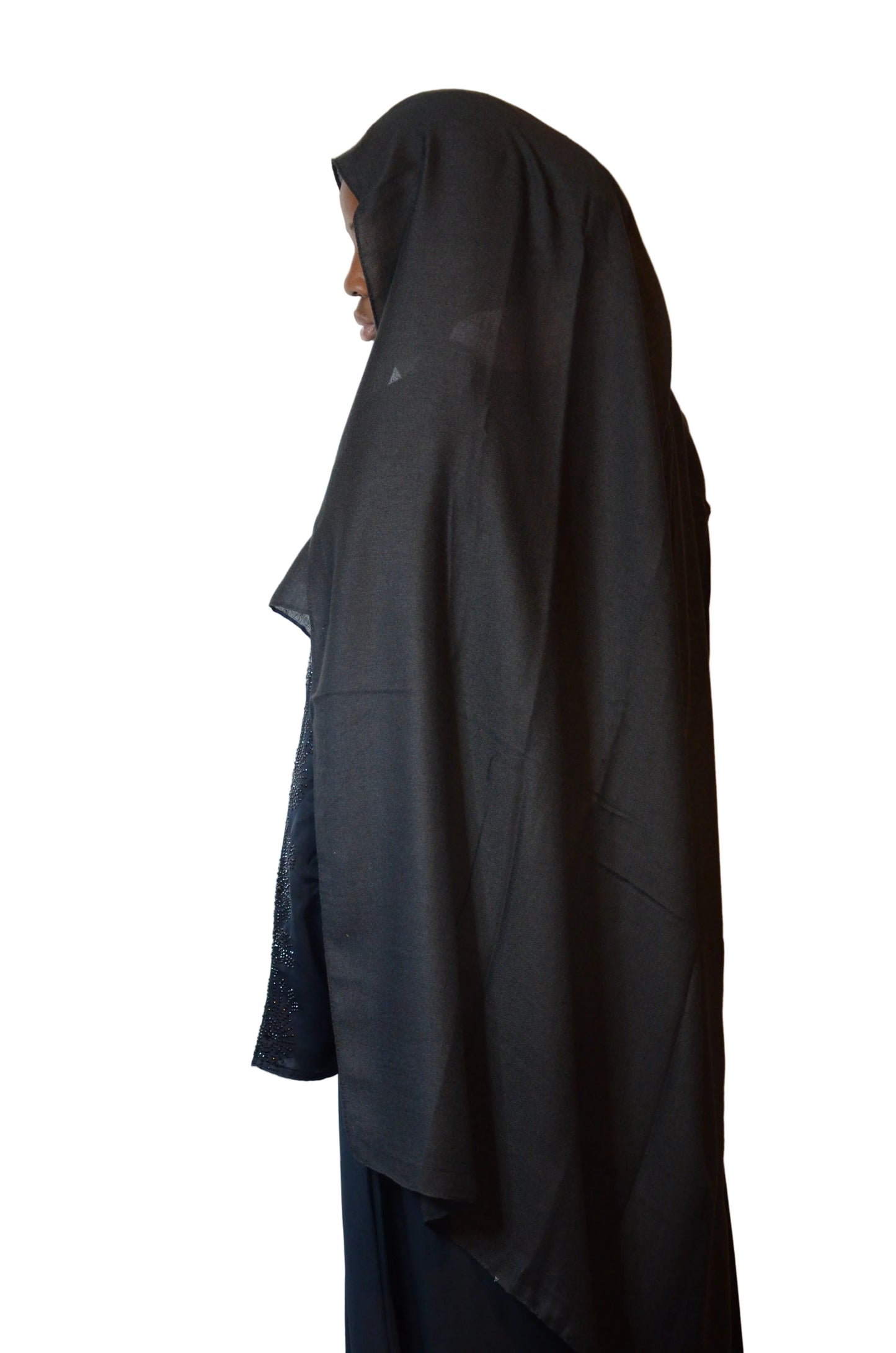 Model wearing a lightweight black cotton linen hijab, shown from the side to highlight natural drape