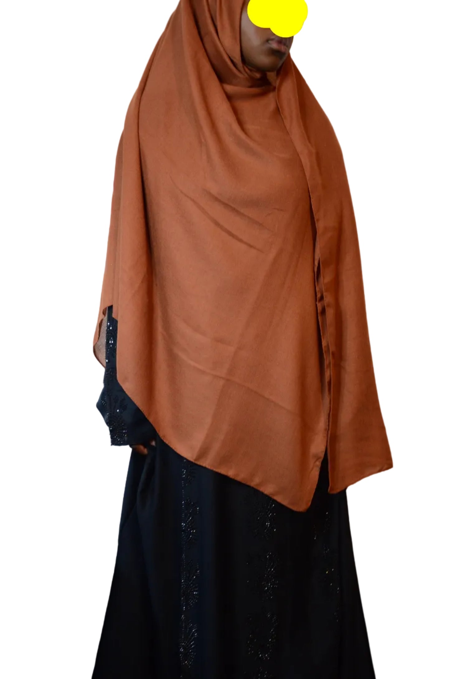 Model wearing a rust brown plain cotton linen hijab draped loosely over the shoulders with a soft natural flow