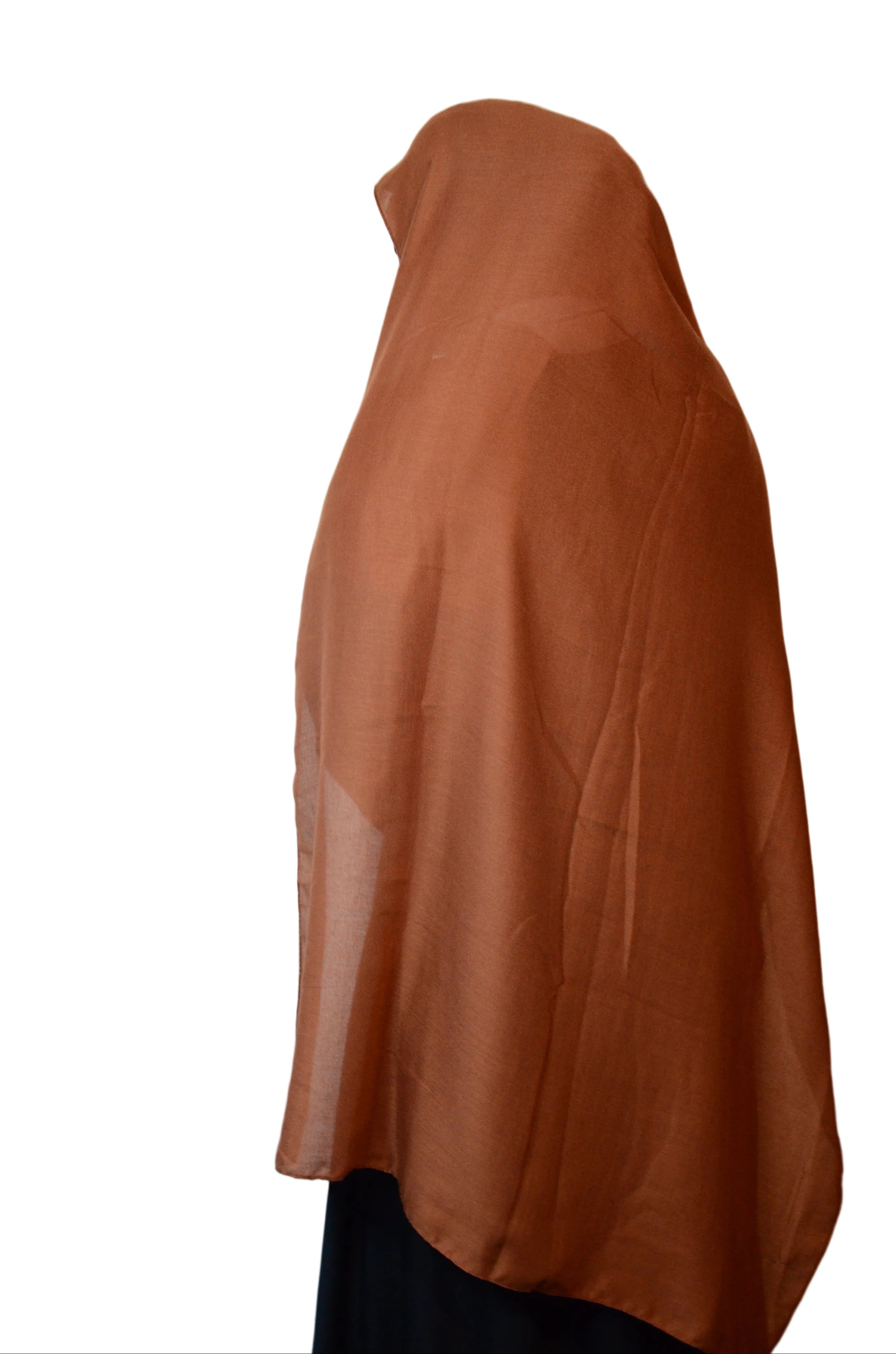 Model wearing a rust brown cotton linen hijab shown from the side, highlighting the lightweight fabric and smooth drape.