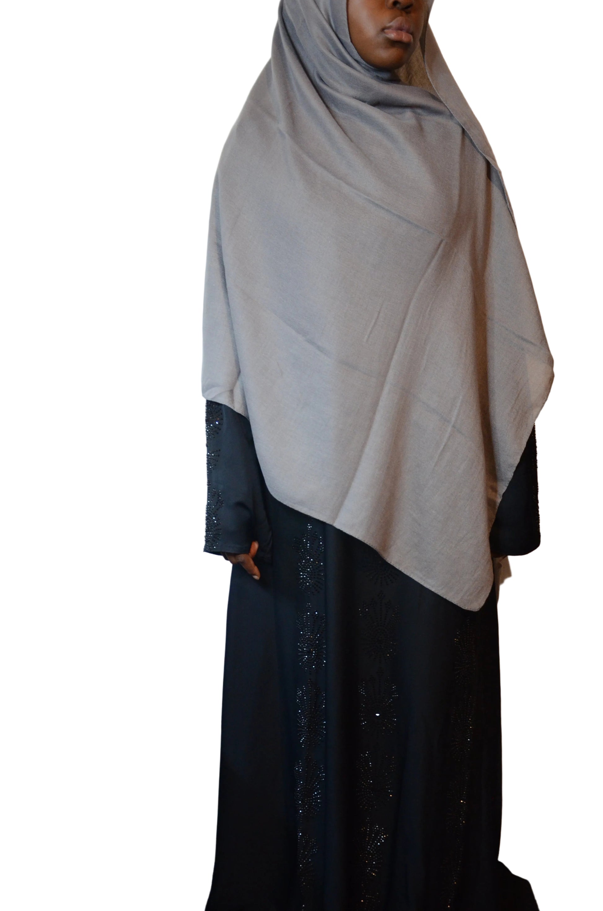 Model wearing a soft grey plain cotton linen hijab styled loosely with a natural drape