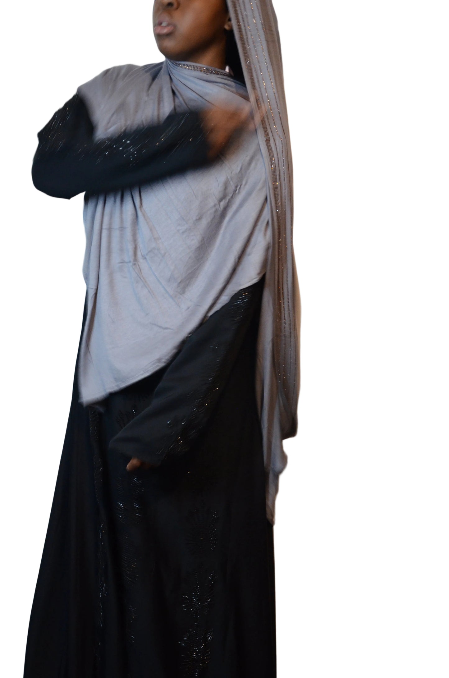 Model wearing a soft grey premium jersey hijab with subtle rhinestone edge, styled loosely over a black abaya.