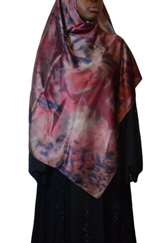 Model wearing a deep berry marble satin-feel hijab draped over the shoulders, showcasing a silky finish and abstract plum-toned print.