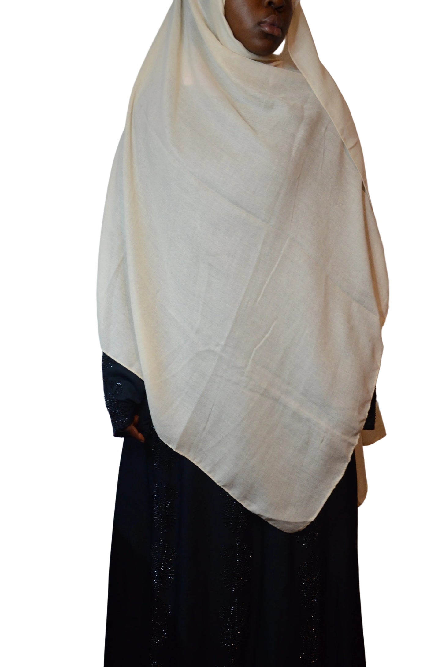 Model wearing an ivory cotton linen hijab styled loosely over a black abaya, showing a soft drape and lightweight texture.