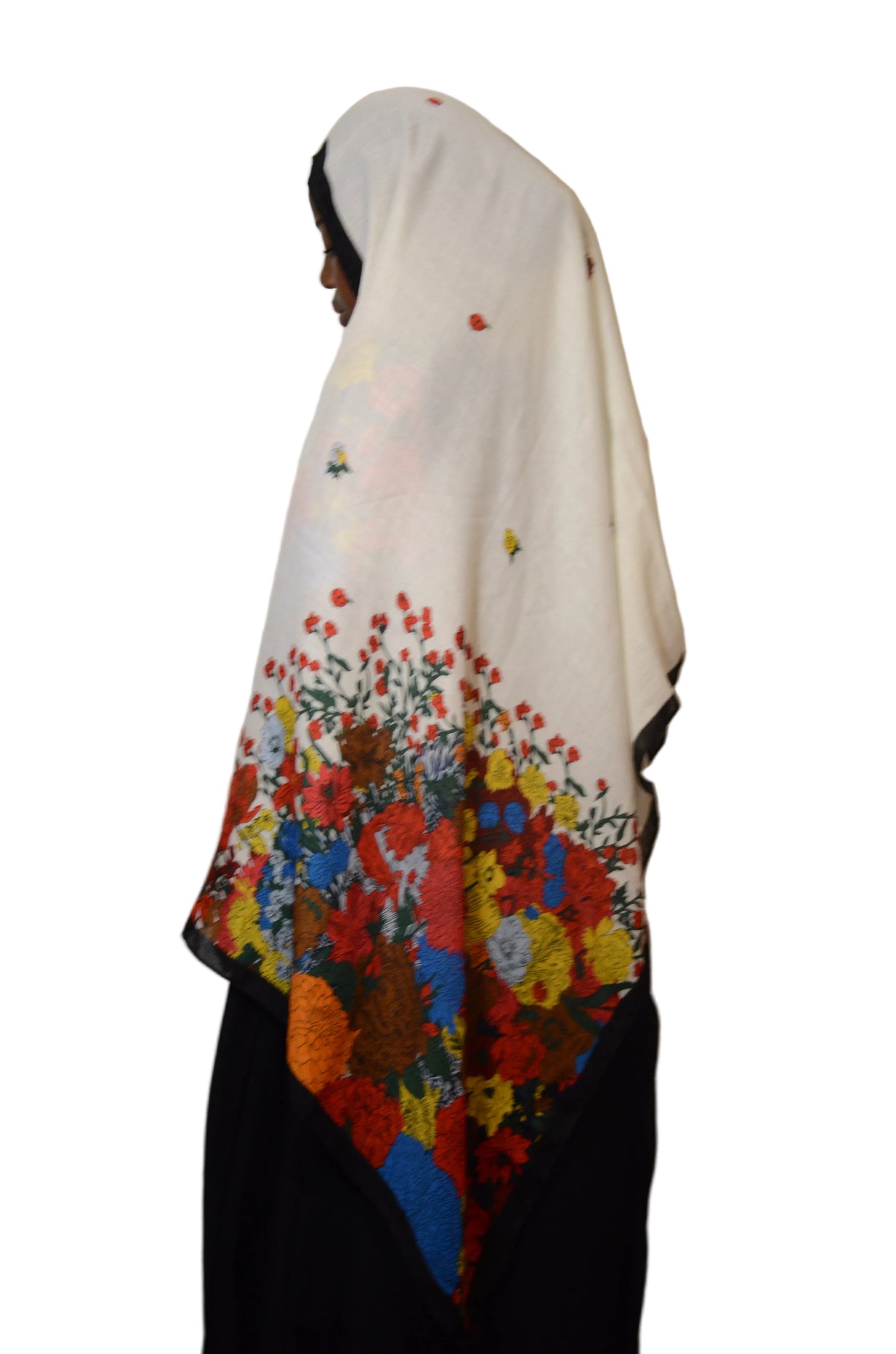 Model wearing a white floral cotton voile linen hijab with multicolour flower print, lightweight fabric draped softly over the shoulders.